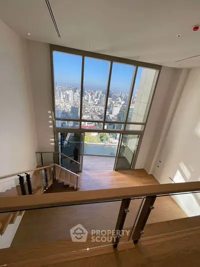 Stunning high-rise apartment with floor-to-ceiling windows offering breathtaking city views.
