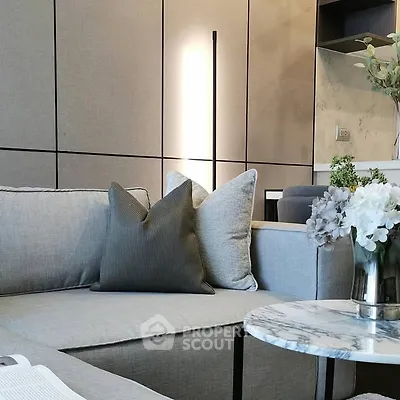 Modern living room with stylish gray sofa and marble coffee table