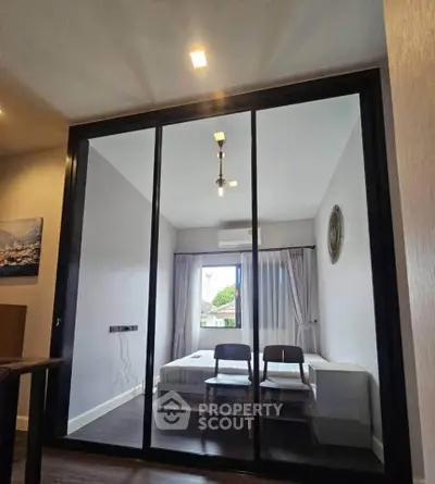Modern bedroom with glass partition and minimalist decor