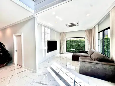 Luxurious modern living room with elegant marble flooring and large windows