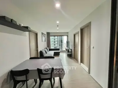 Modern living room with sleek furniture and balcony view in a contemporary apartment.