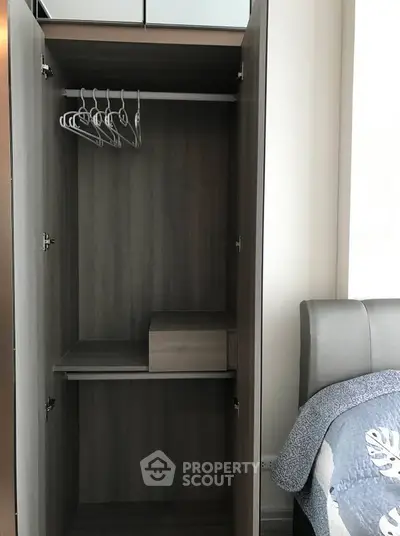 Spacious bedroom wardrobe with modern design and ample storage space.