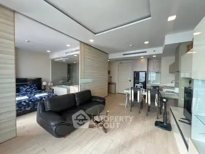 Modern open-plan living room with sleek furniture and stylish decor in a contemporary apartment.