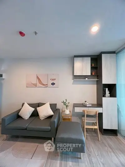 Modern living room with stylish furniture and built-in shelving, perfect for urban living.