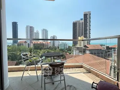 Stunning balcony view of city skyline and ocean, perfect for relaxation.