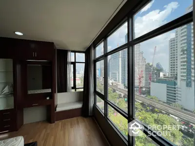 Spacious corner unit with large windows offering a stunning city view, perfect for urban living.