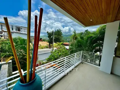 Spacious balcony with lush greenery and scenic mountain views