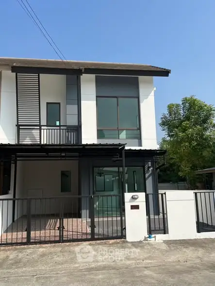 Modern two-story townhouse with sleek design and spacious balcony