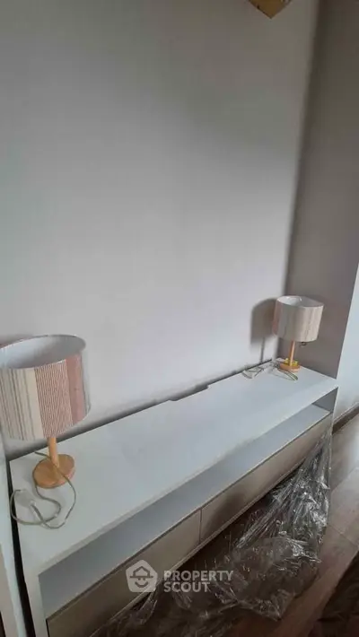 Modern interior with stylish lamps and sleek console table, perfect for contemporary living spaces.