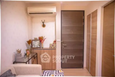Charming entryway with modern decor and air conditioning in cozy apartment.
