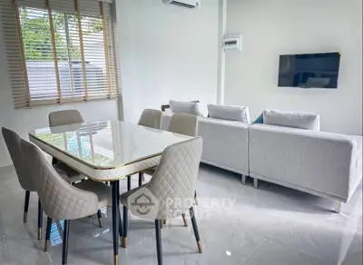 Modern living room with elegant dining area and stylish furniture