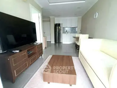 Modern living room with sleek furniture and open kitchen layout
