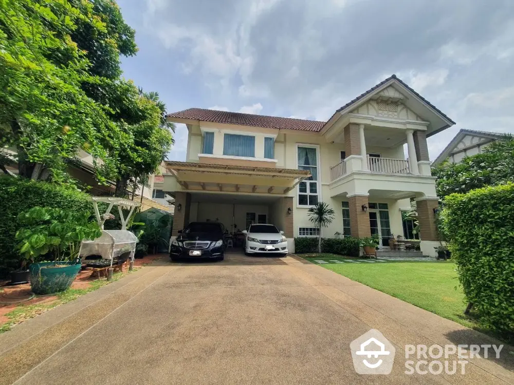 Elegant two-story house with spacious driveway and lush garden