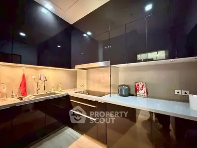 Modern kitchen with sleek black cabinets and white countertops