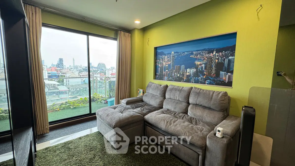 Modern living room with city view and cozy gray sofa