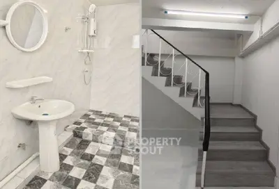 Spacious bathroom with modern fixtures and adjacent staircase in a stylish interior.