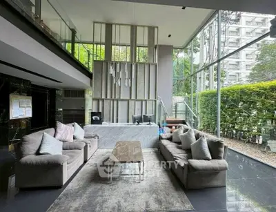 Luxurious modern living room with floor-to-ceiling windows and elegant decor