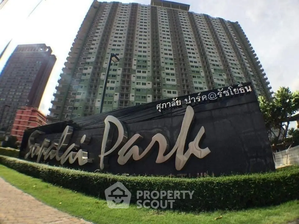 Modern high-rise condominium building with landscaped entrance at Sukatai Park.