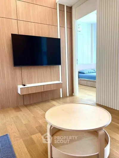 Modern living room with sleek wooden paneling and wall-mounted TV