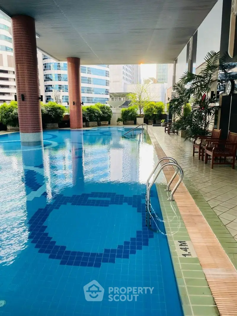 Luxurious urban swimming pool with city views and elegant seating area.