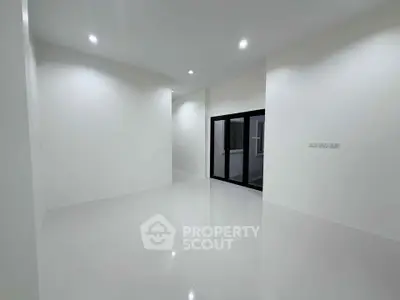 Spacious modern living room with sleek white tiles and recessed lighting