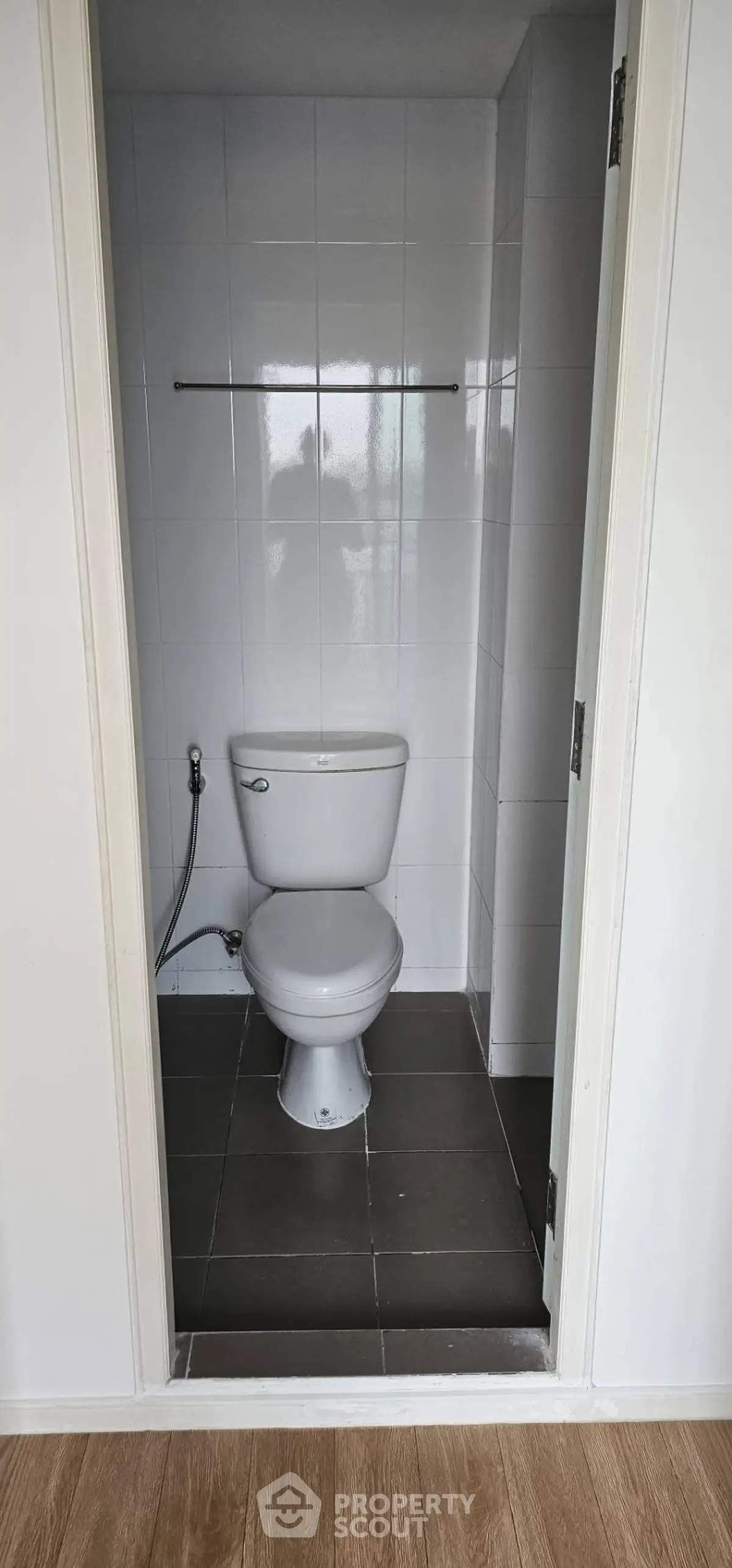 Compact bathroom with modern toilet and tiled walls, ideal for small spaces.