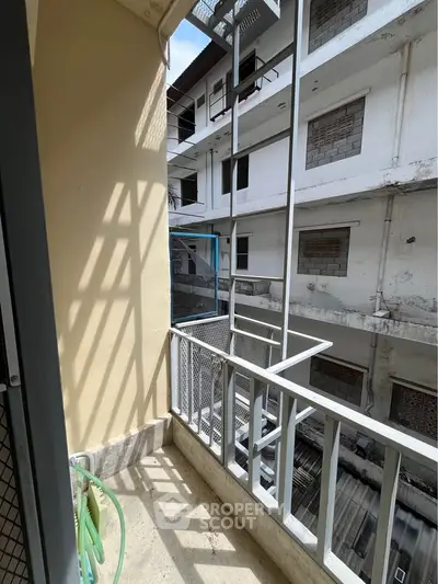 Urban balcony with metal railing and city view