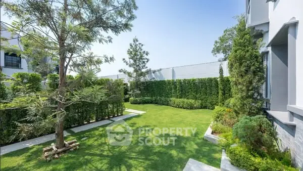 Luxurious garden with lush greenery and modern landscaping in a serene residential area.