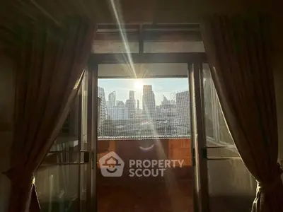 Stunning city view from a cozy balcony at sunset, perfect for urban living.