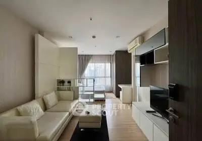 Modern living room with sleek furniture and large windows offering natural light.