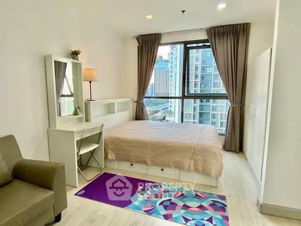 Modern bedroom with city view, featuring cozy bed and stylish decor.