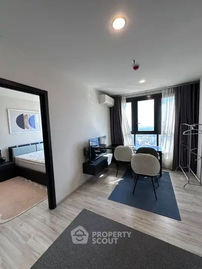 Modern apartment living room with city view and adjacent bedroom