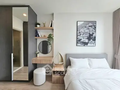 Modern bedroom with stylish decor, featuring a cozy bed, sleek wardrobe, and elegant wall art.