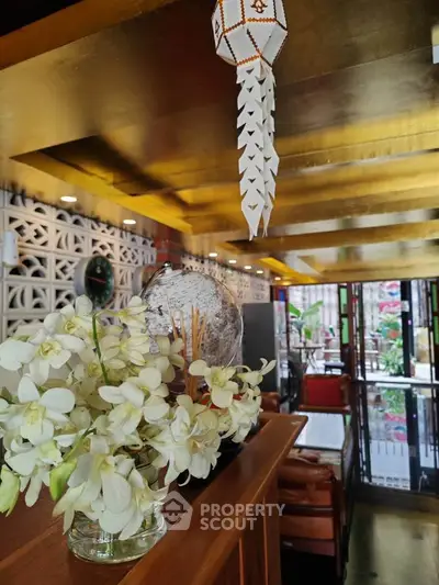 Charming interior with elegant decor and floral arrangement in a cozy living space.