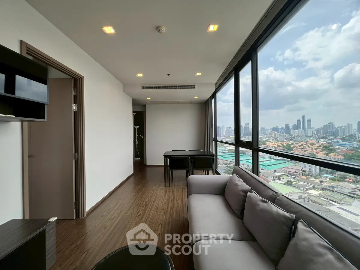 Spacious living room with stunning city view and modern furnishings
