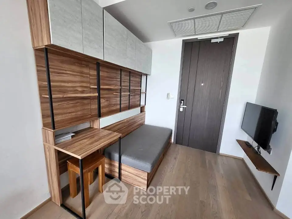 Modern compact living space with stylish wood accents and wall-mounted TV