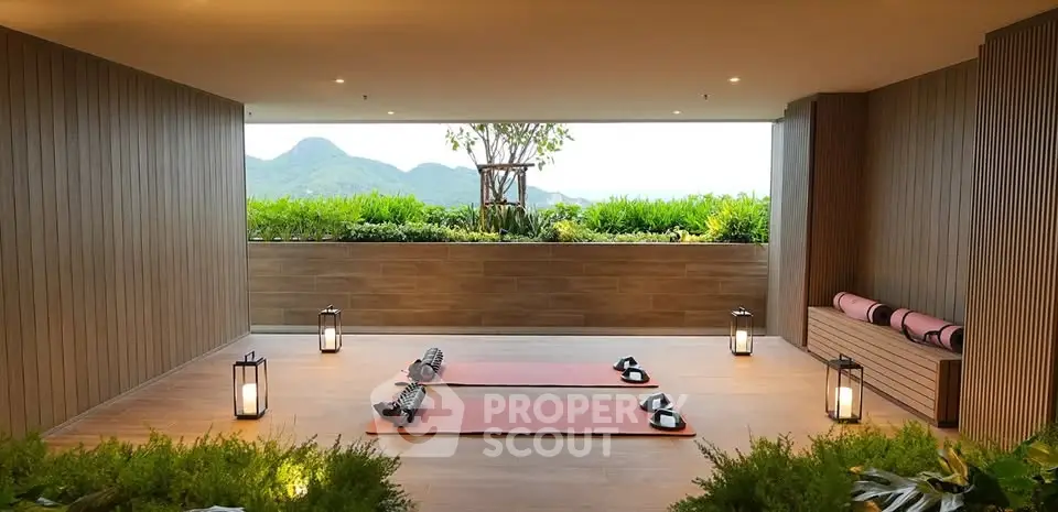 Luxurious yoga space with mountain view and serene ambiance in modern building.
