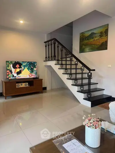 Stylish living room with modern staircase and elegant decor