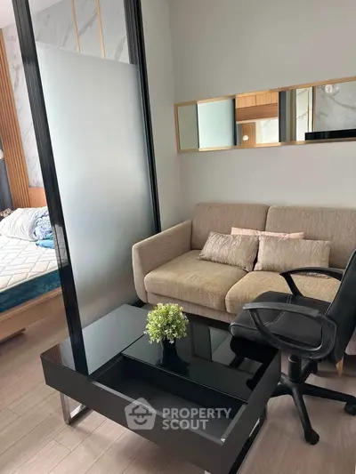 Modern living room with cozy sofa, sleek black table, and stylish decor in a contemporary apartment.