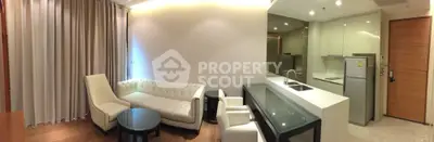 Modern open-layout living room with sleek kitchen and elegant furniture