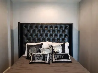 Luxurious bedroom with elegant black tufted headboard and stylish pillows