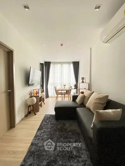 Modern living room with sleek furniture and natural light, perfect for relaxation and entertainment.