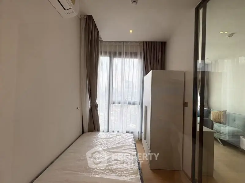 Modern minimalist bedroom with large window and natural light