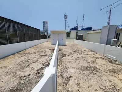 Spacious rooftop area with city views and utility structures, ideal for urban living enhancements.