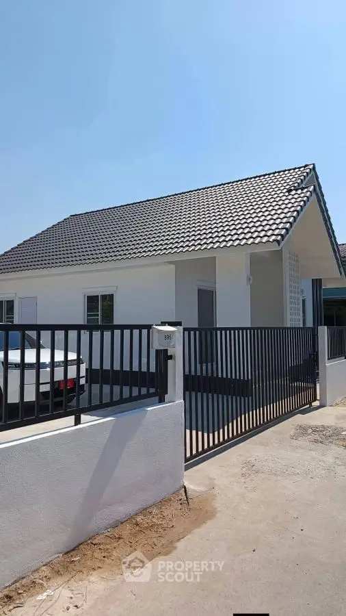 Charming single-story house with modern design and gated driveway