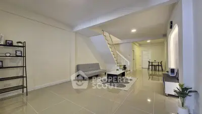 Spacious modern living room with sleek design and staircase