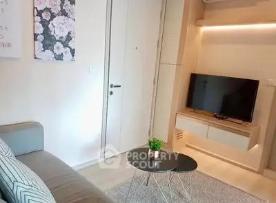 Modern living room with sleek TV unit and cozy seating area
