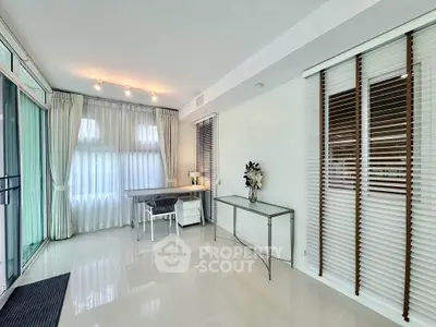 Spacious modern living room with elegant decor and large windows for natural light.