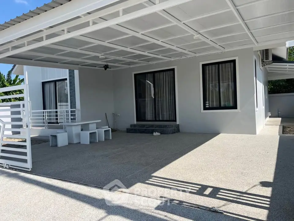 Modern single-story home with spacious covered patio and sleek design.