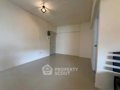 Spacious empty room with modern lighting and neutral tones, perfect for customization.